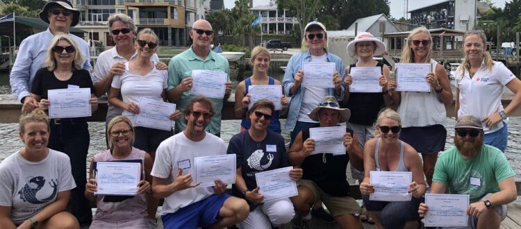 Group of people holding certificates of training